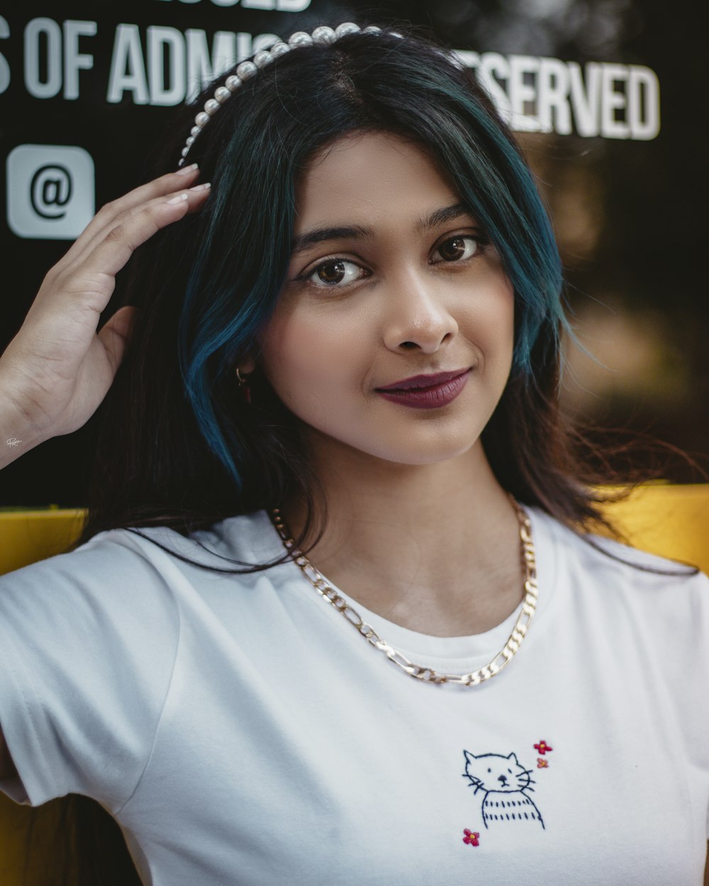 a woman with blue hair wearing a white shirt