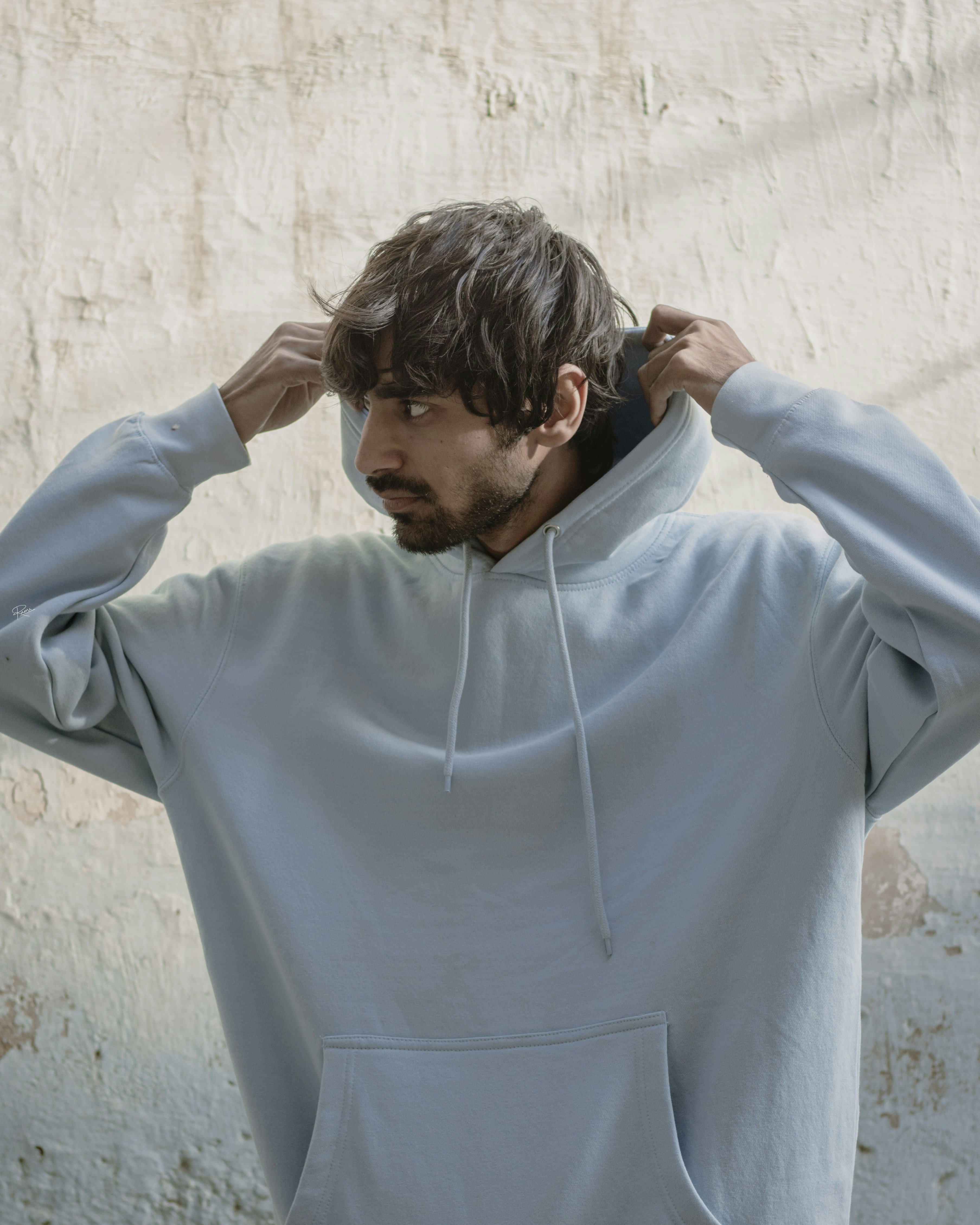 a man with his hands on his ears