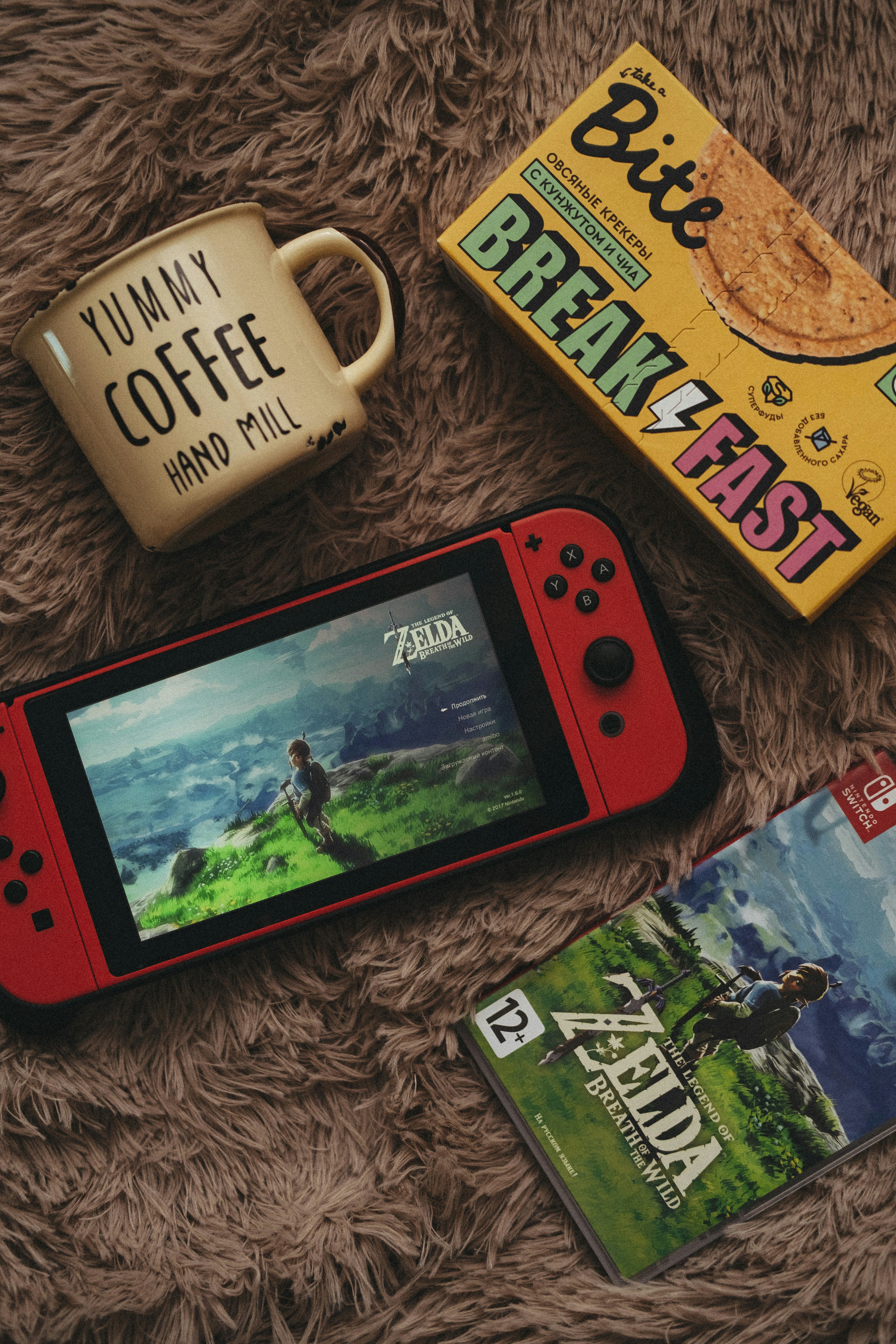 A cozy gaming setup with a journal and coffee mug.