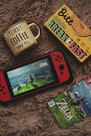 A cozy gaming setup with a laptop displaying namatoto’s game interface and a cup of coffee nearby.