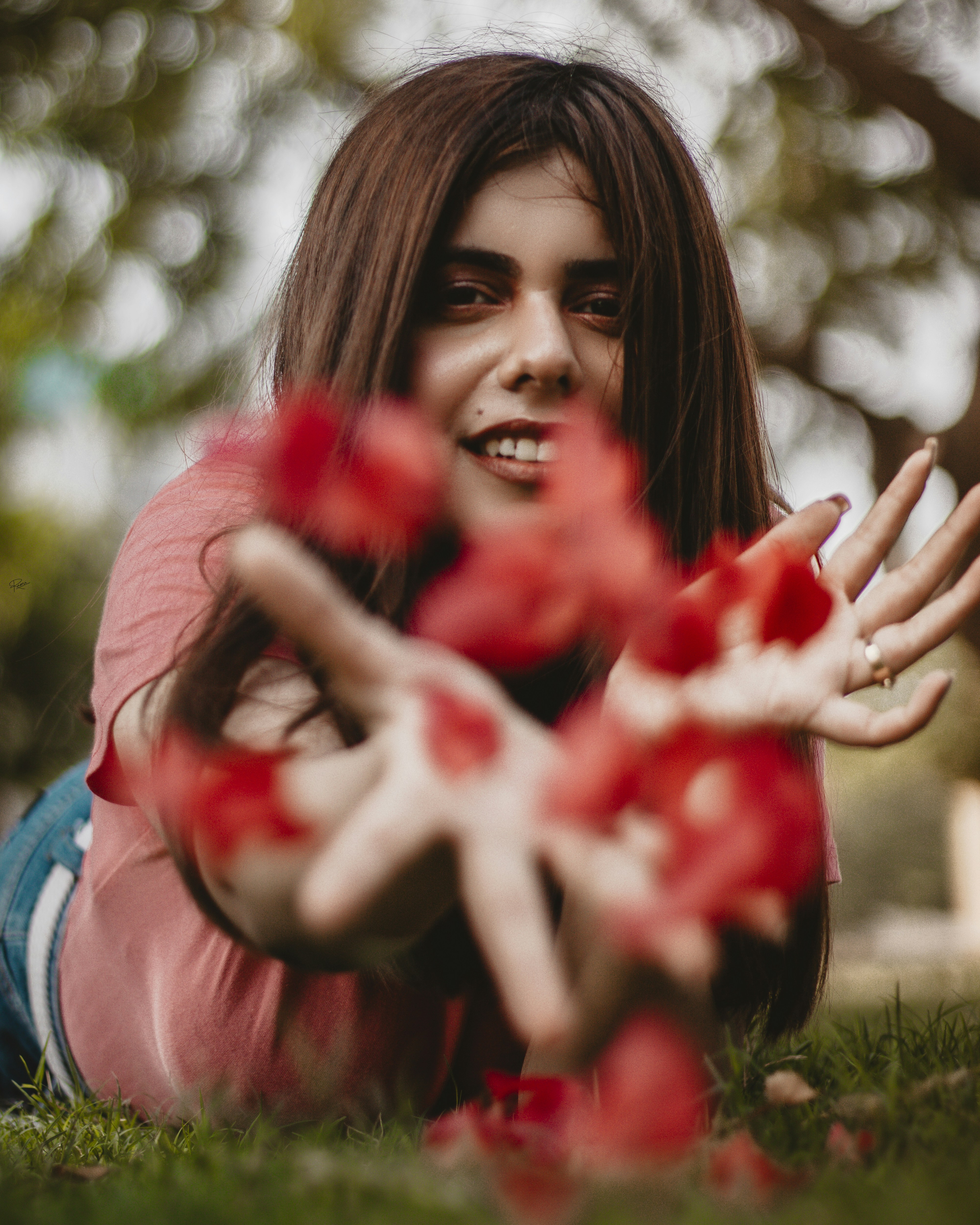 a woman laying on the ground with her hands in the air