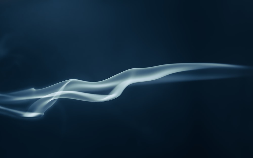 a blue background with white smoke coming out of it