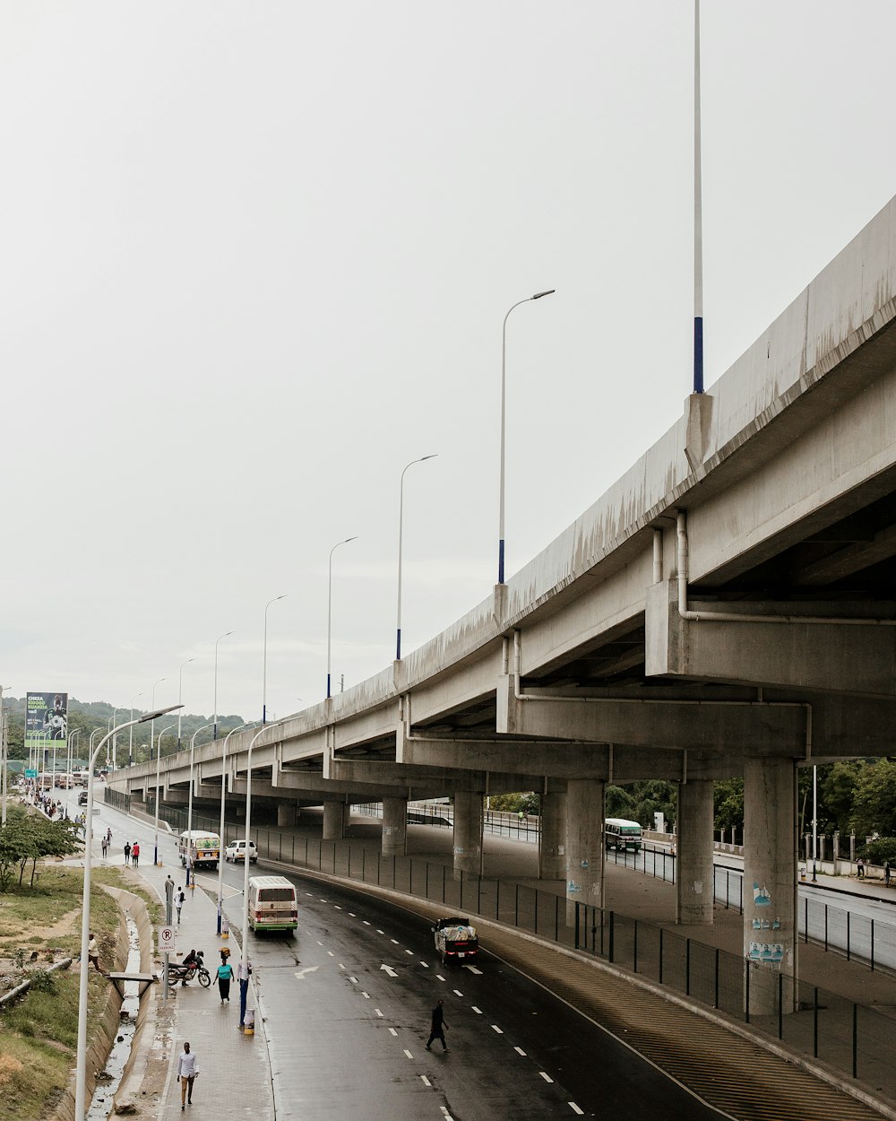 a highway with cars and people walking on the side of it