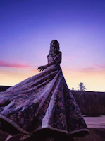 Runway shot featuring a flowing dress blending traditional patterns with futuristic cuts.