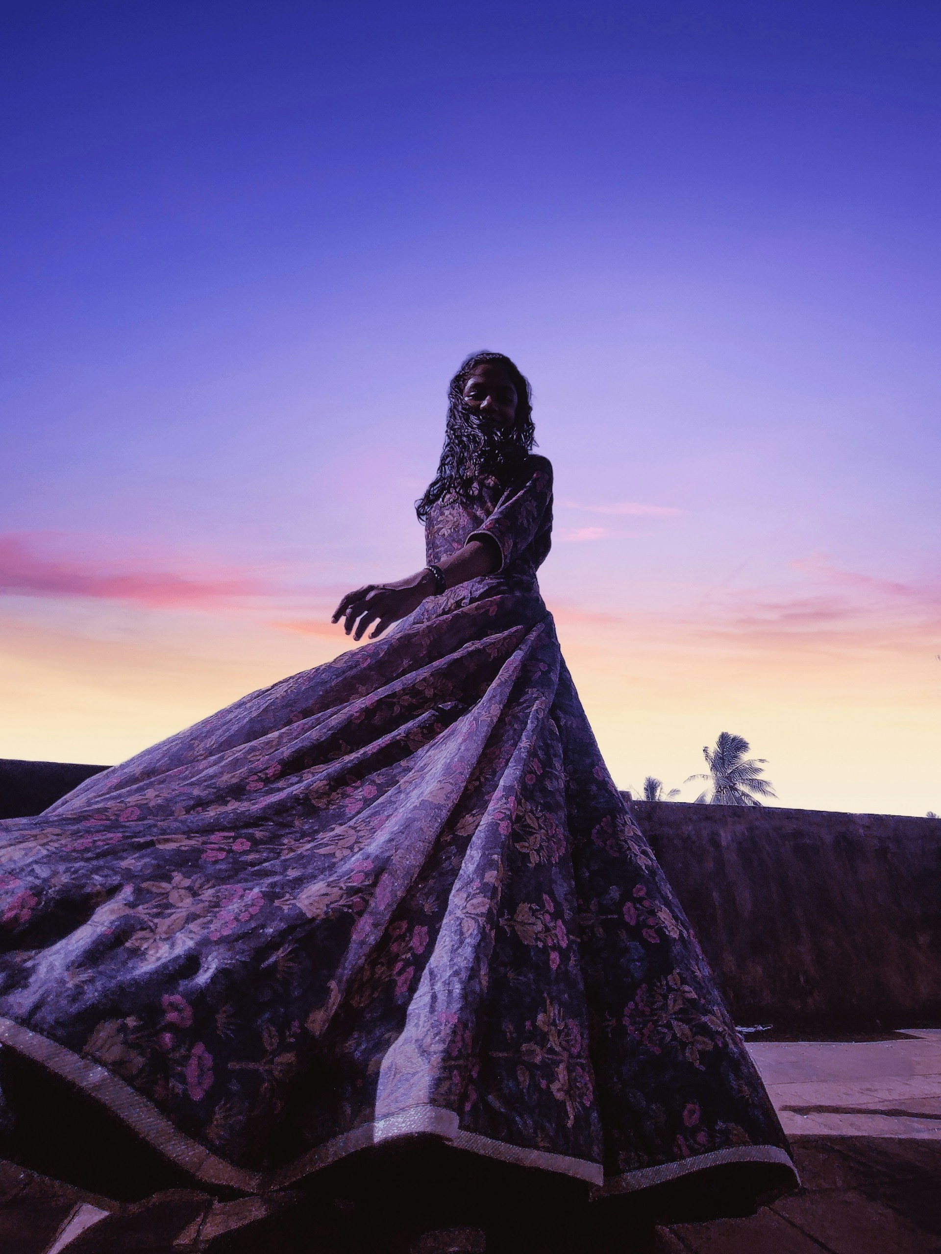 A graceful gamis dress with soft flowing fabric showcased against a warm, inviting background.