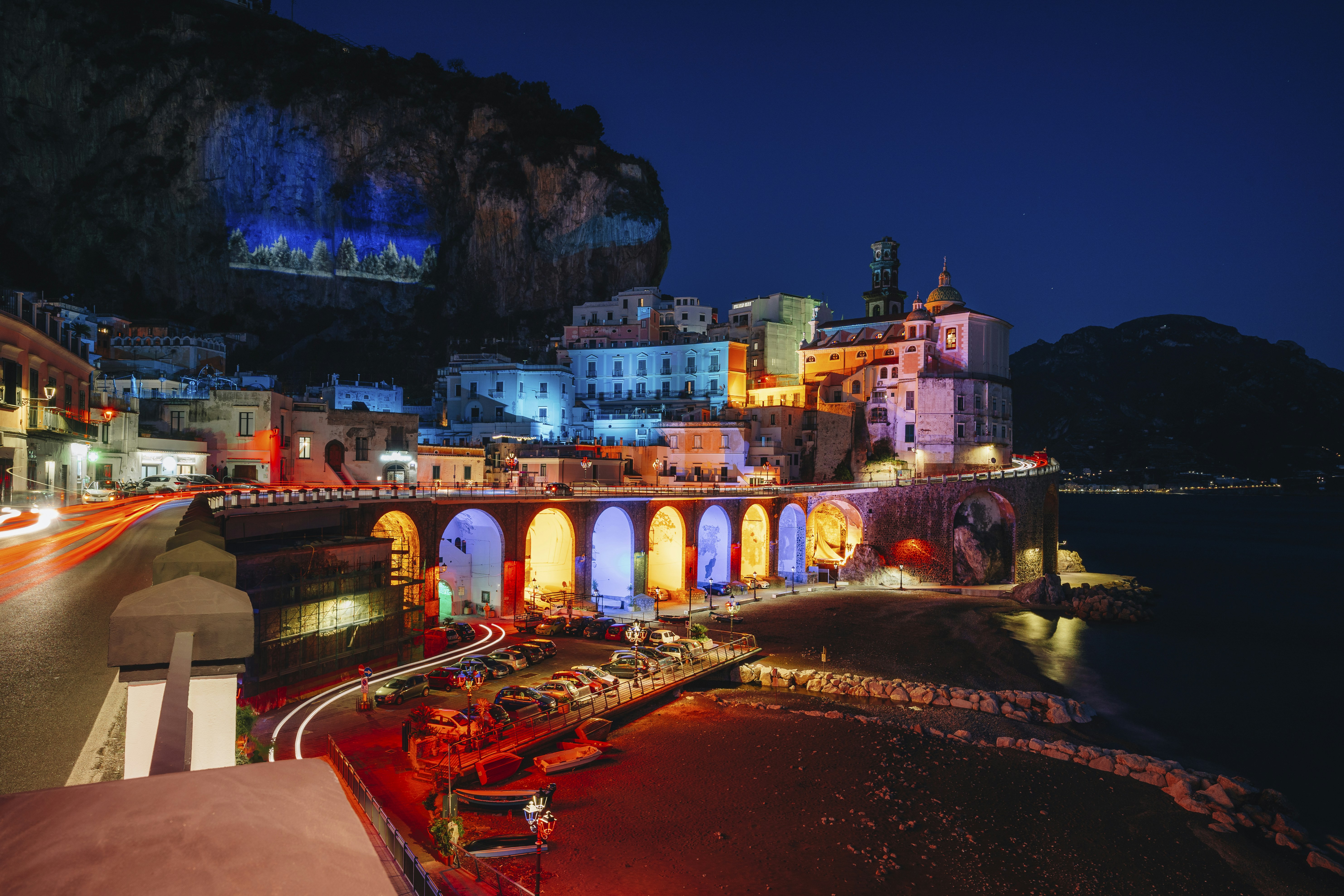 a night time view of a city with a bridge