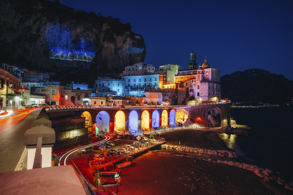 a night time view of a city with a bridge