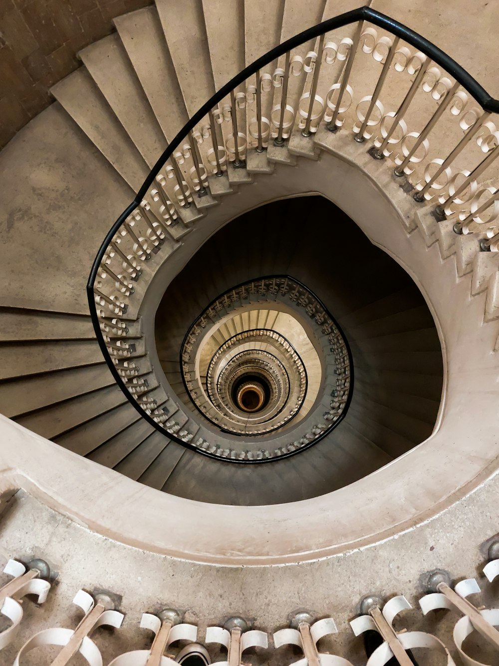 a spiral staircase in a building with white railings