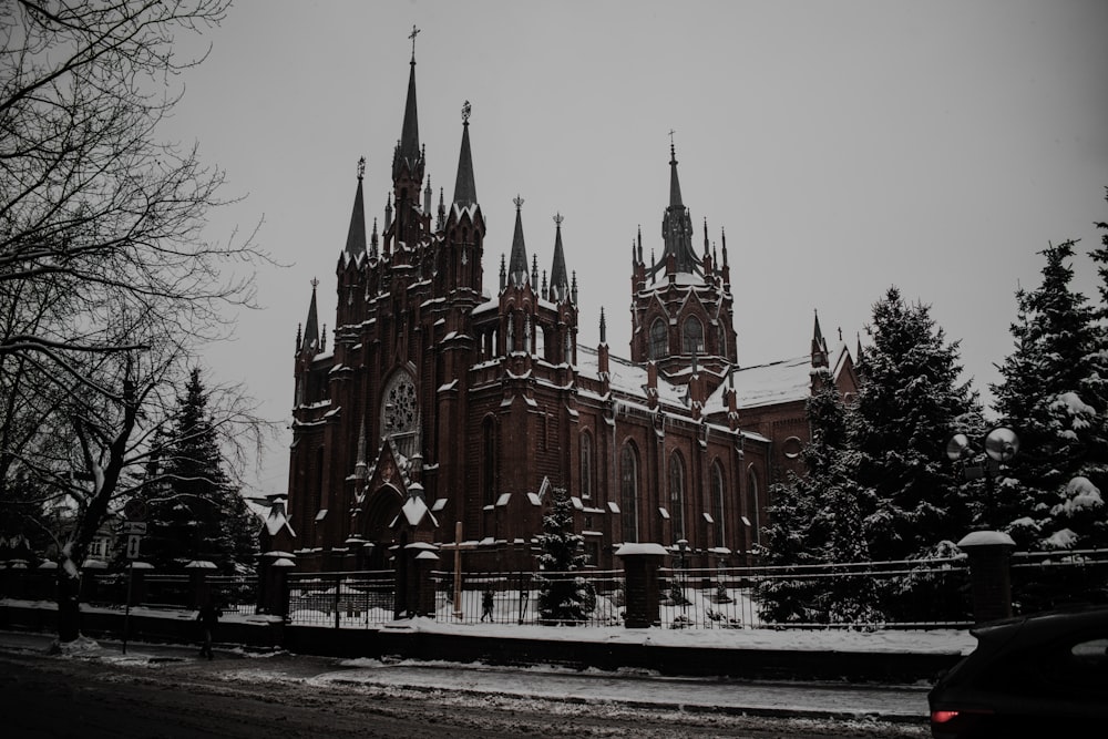 a large church with a clock tower in the snow