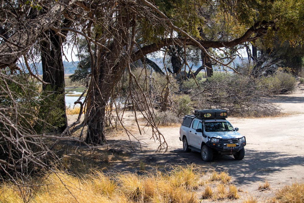 a car parked on the side of a dirt road