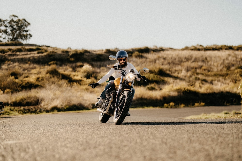 a man riding a motorcycle down a curvy road