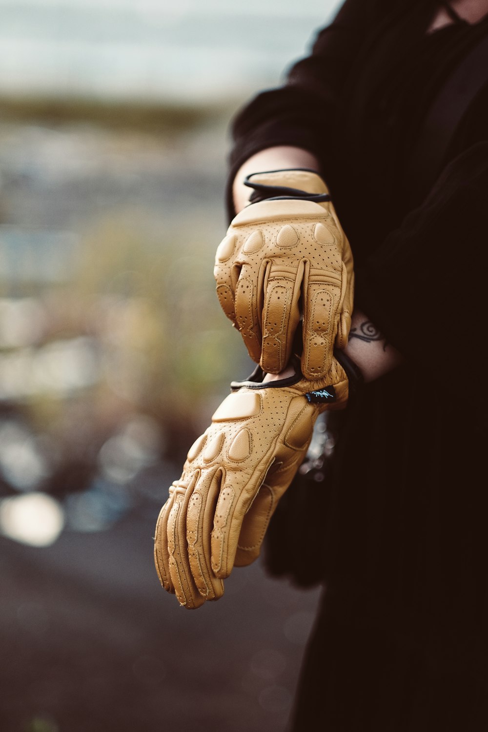 a person wearing a pair of yellow gloves