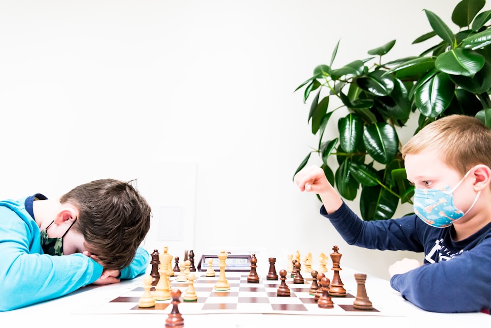 a man and a young boy playing a game of chess