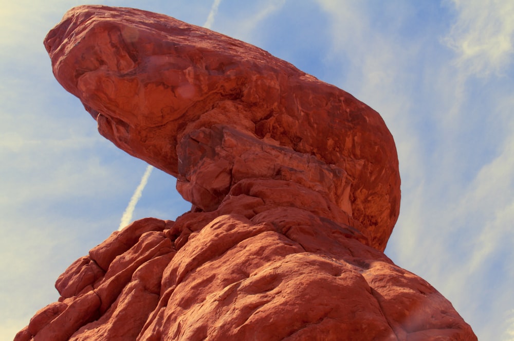 a large rock formation with a sky background