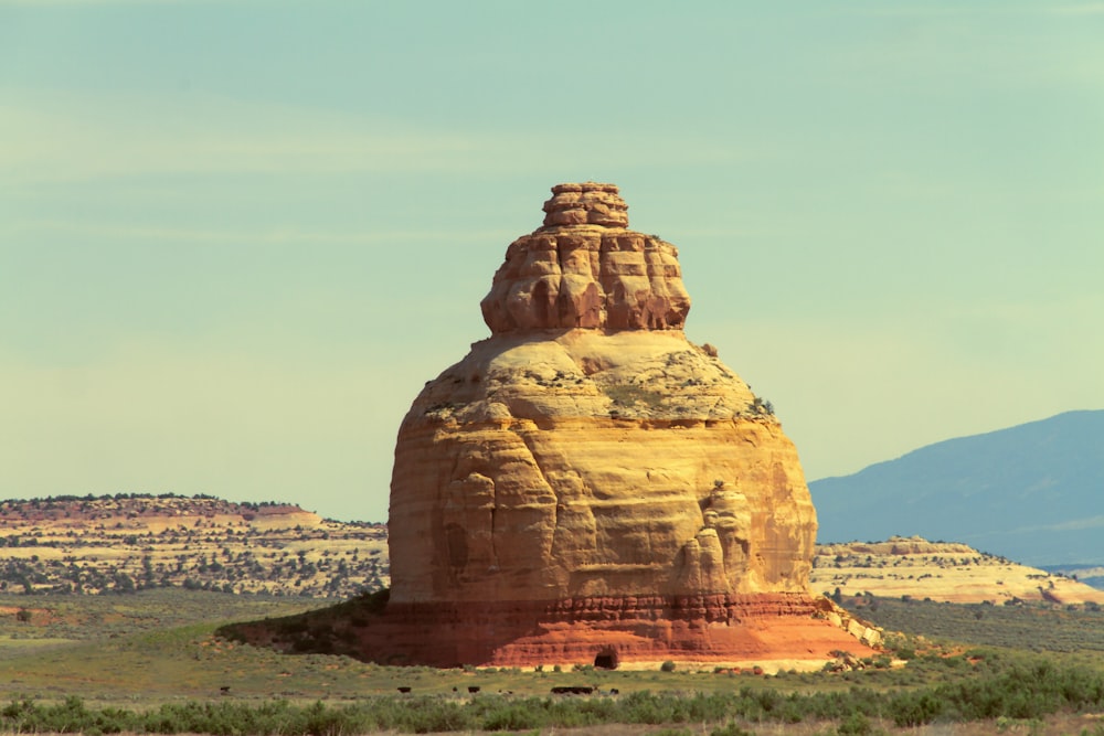 a large rock formation in the middle of a desert