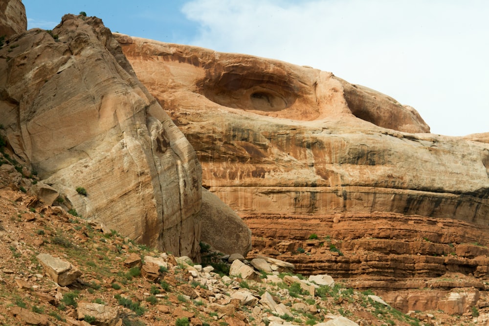 a rocky cliff with a face carved into it