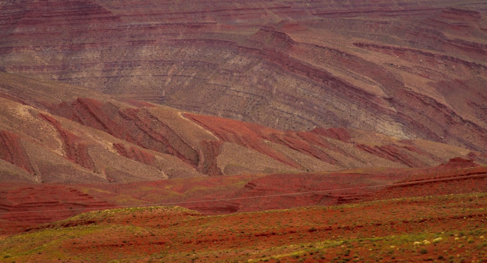 a lone sheep standing in the middle of a mountain range