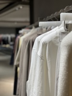 Finished business uniforms hanging on a rack, ready for delivery.