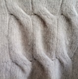 a close up of a person's hand in a sweater