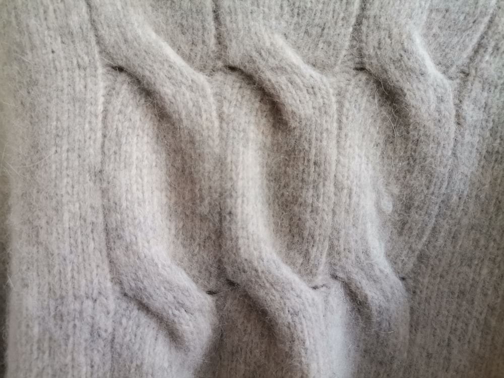 a close up of a person's hand in a sweater