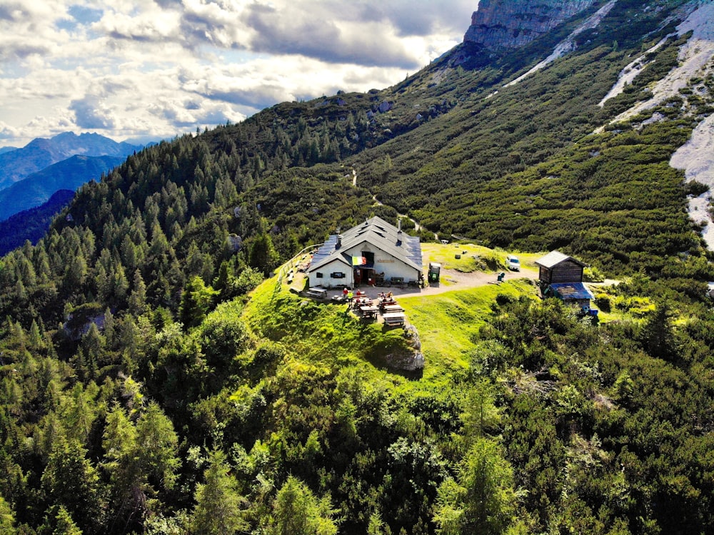 an aerial view of a house in the mountains