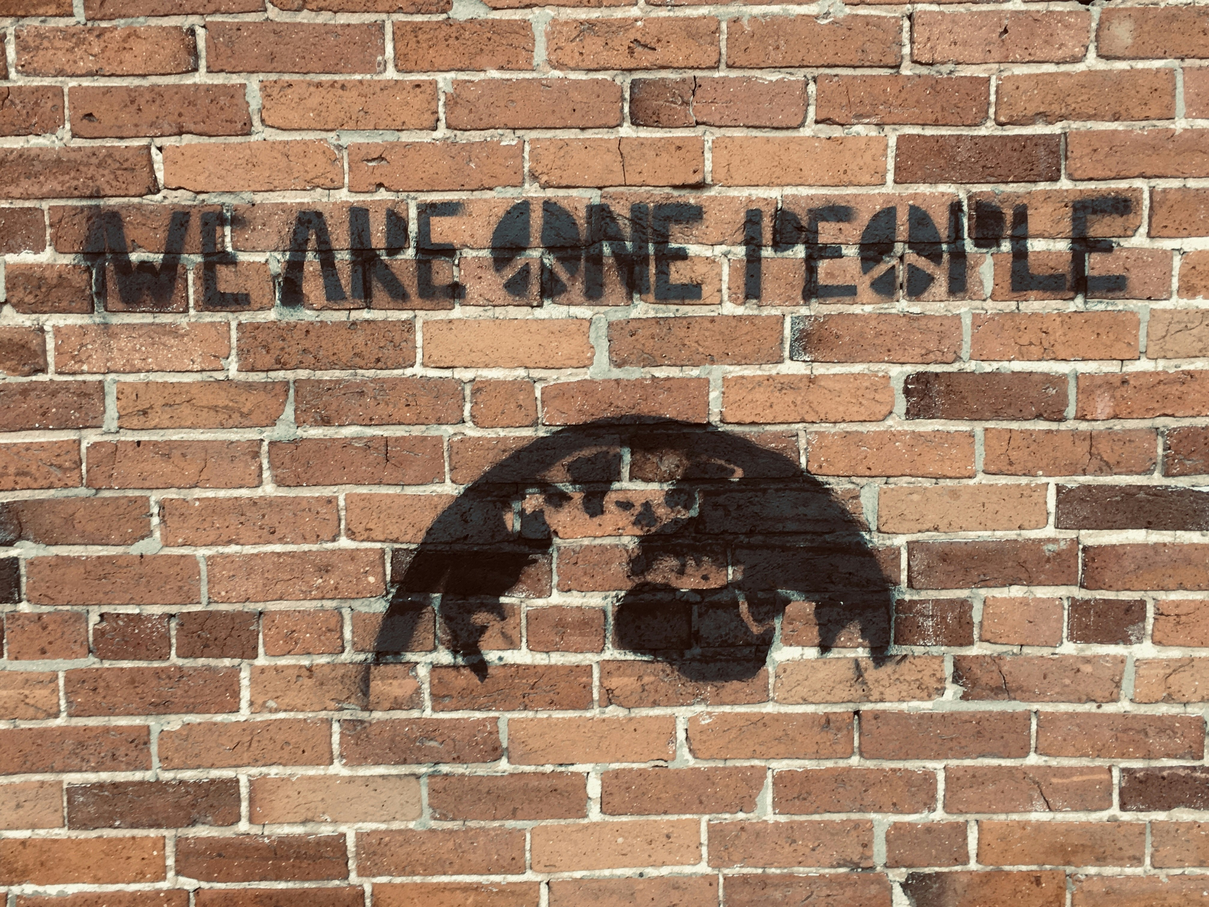 a brick wall with a bear painted on it