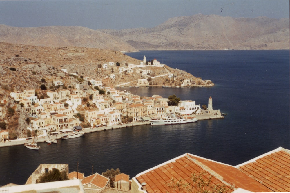 a view of a small town on the coast of a body of water