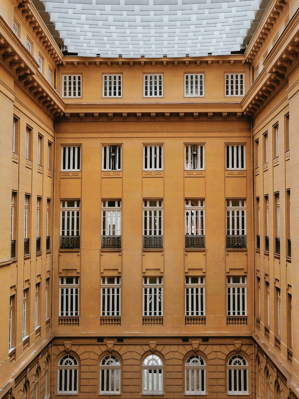 a tall building with many windows and balconies