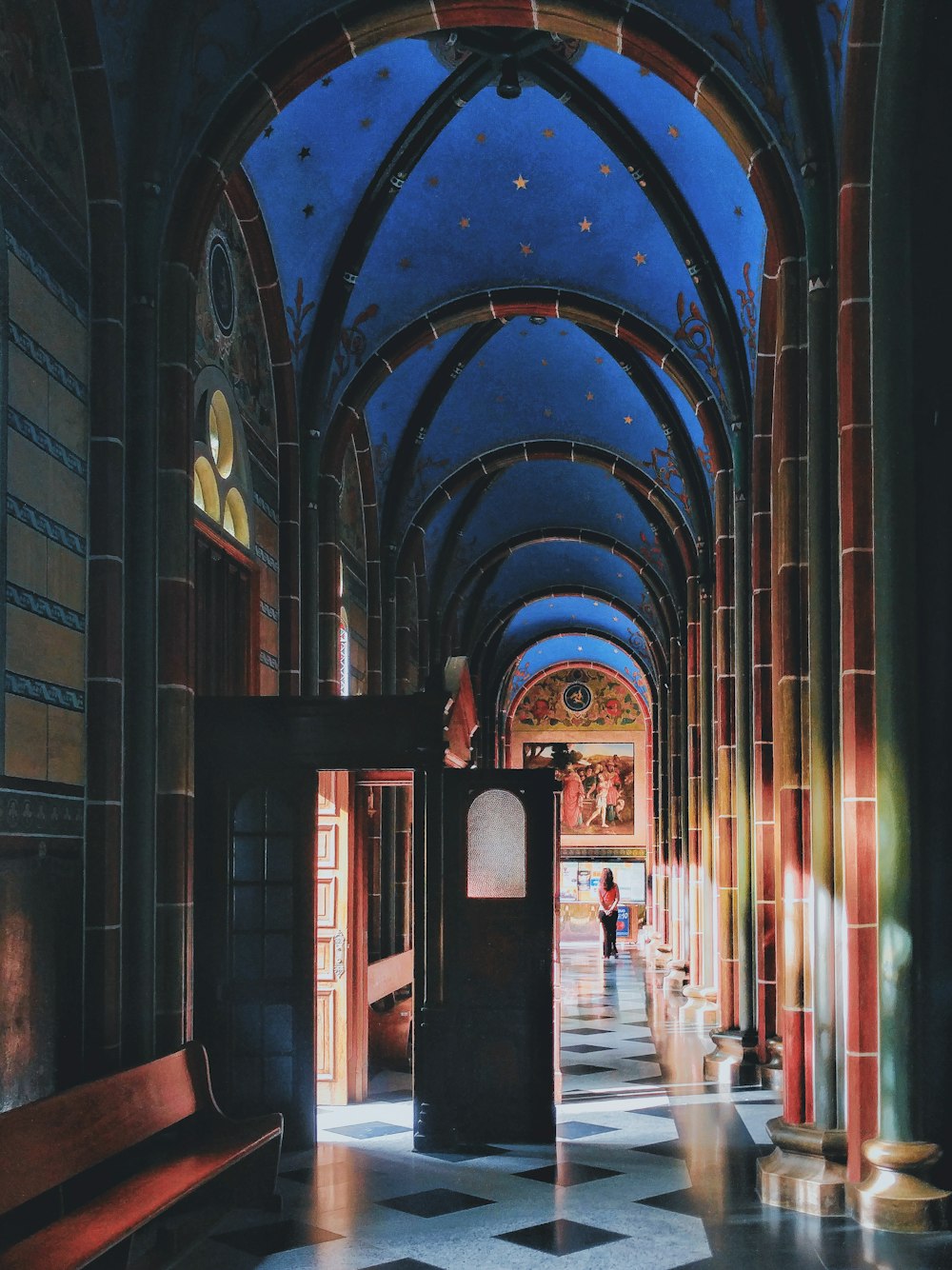 a long hallway with a clock and a bench