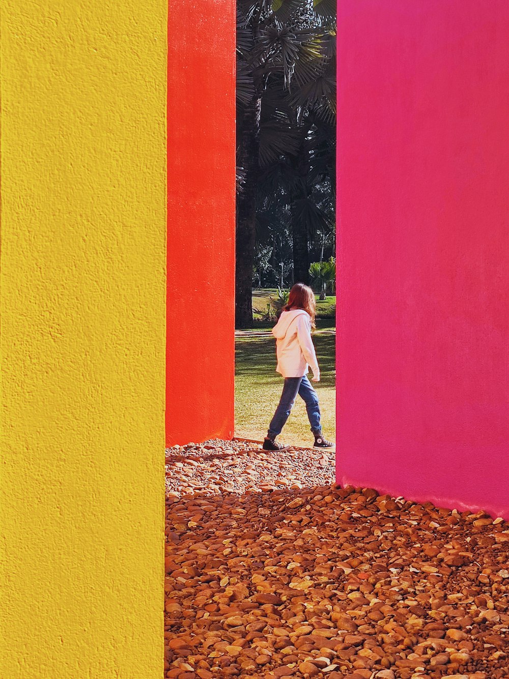 a person walking through a room with multiple colored walls