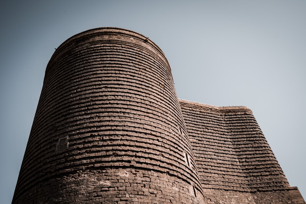 a tall brick building with a sky background