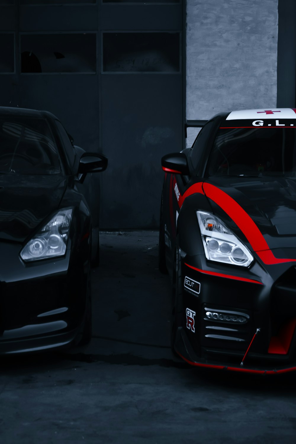 two cars parked next to each other in a garage