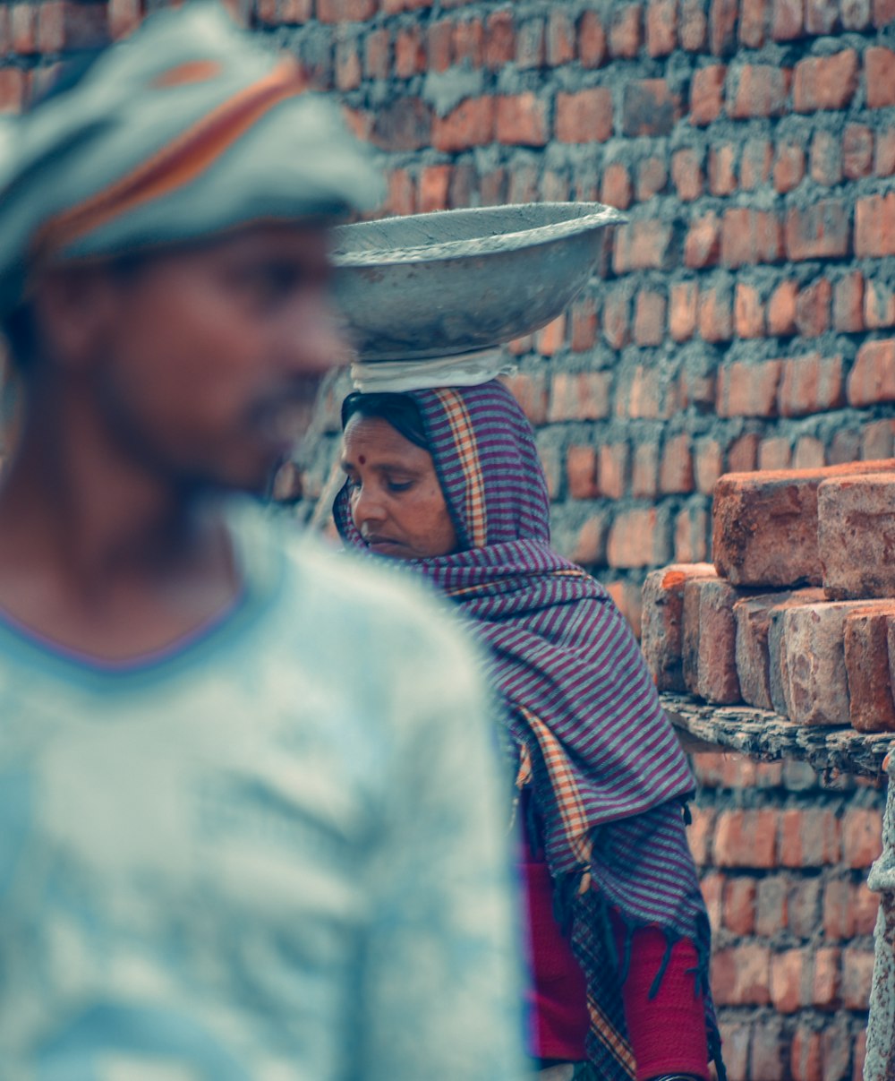 a woman carrying a bucket on her head