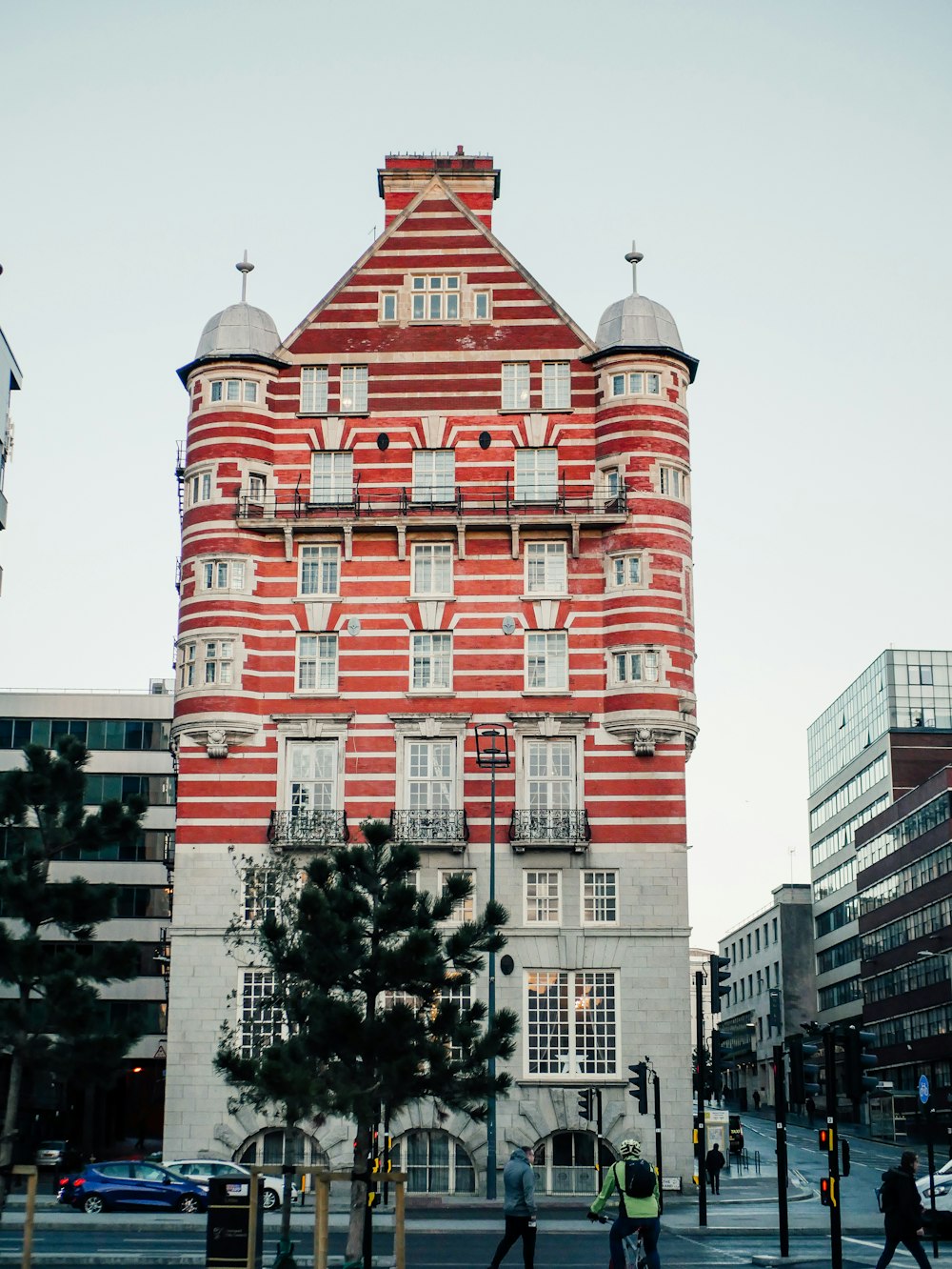 a tall red brick building sitting on the side of a street