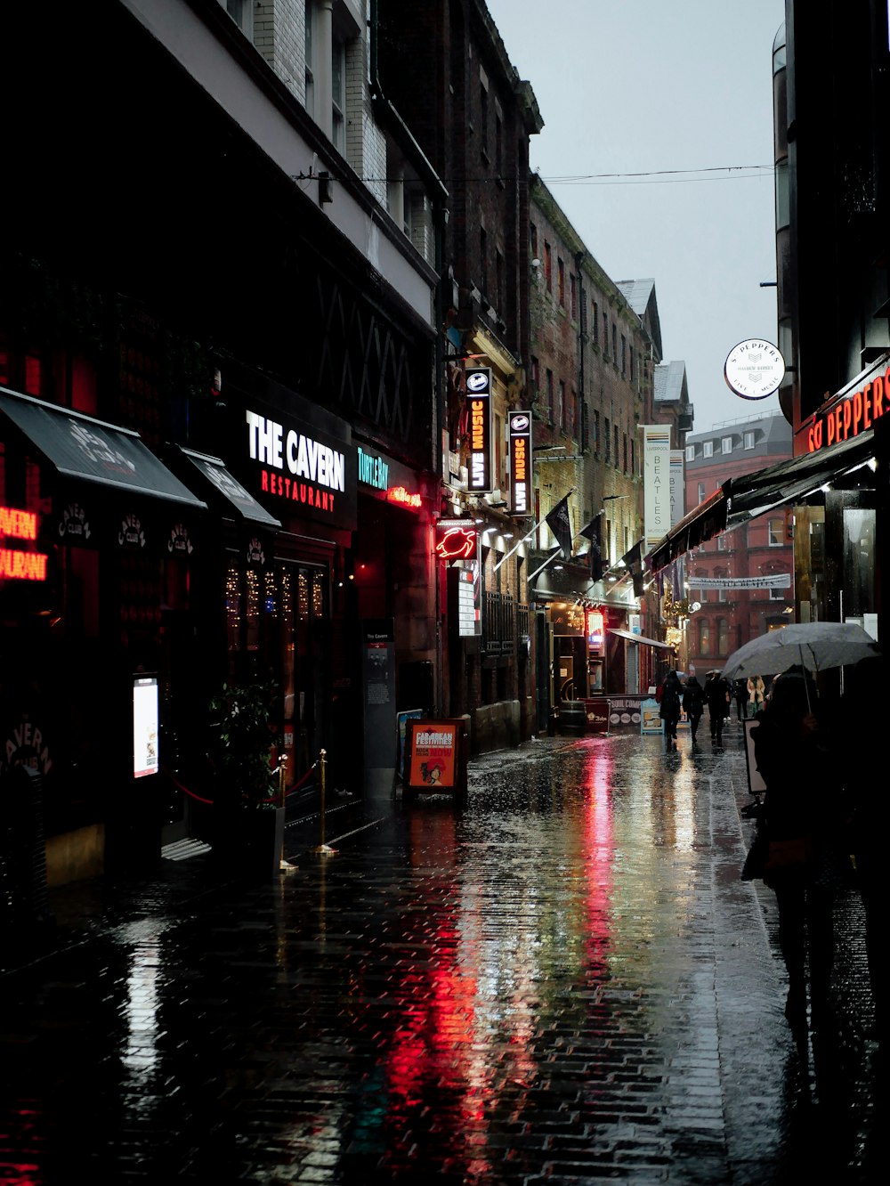 a person walking down a street holding an umbrella