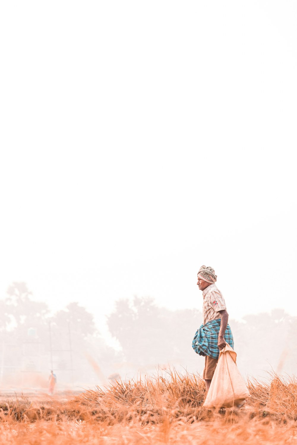 a woman standing in a field of tall grass