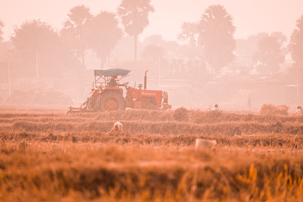 a tractor is driving through a field in the fog