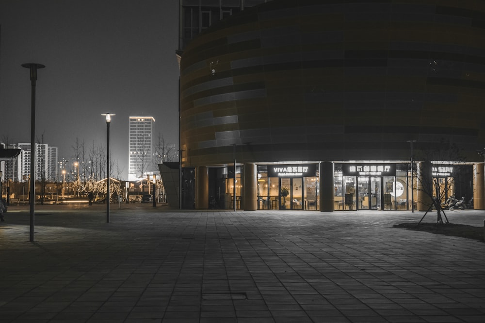 an empty parking lot with a building in the background