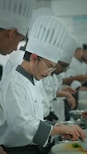 a group of chefs preparing food in a kitchen
