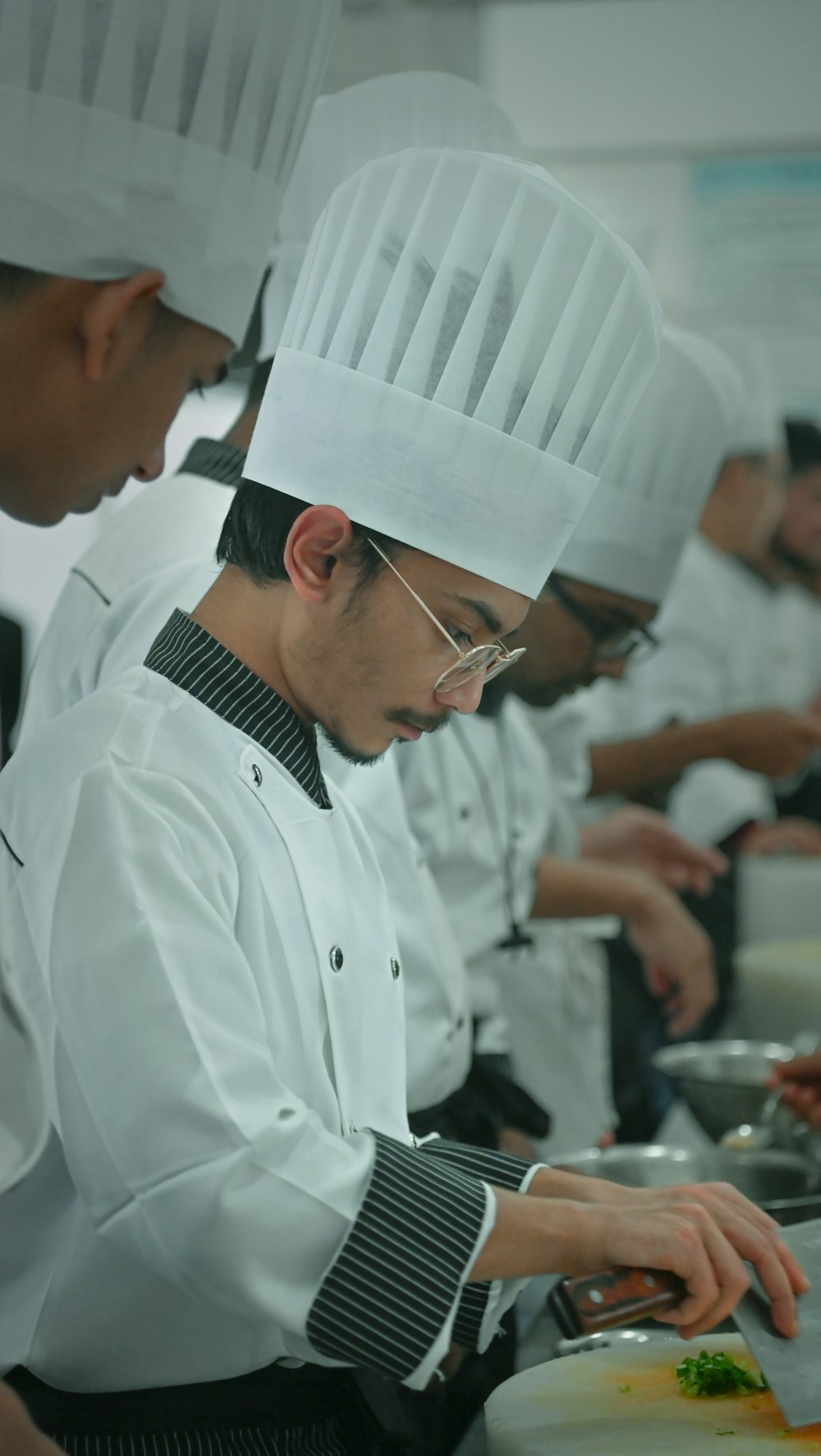 a group of chefs preparing food in a kitchen