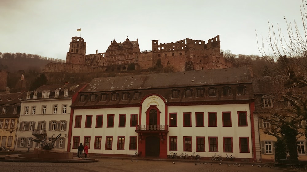 a large white and red building with a castle on top of it