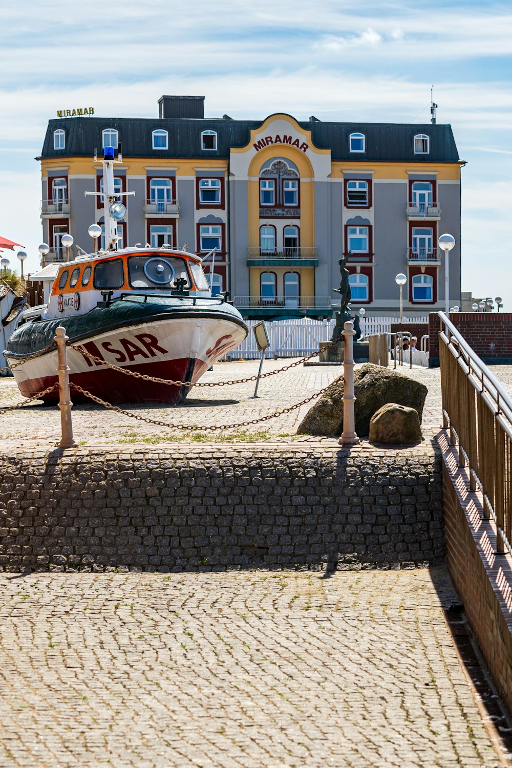 a boat tied up to a dock next to a building