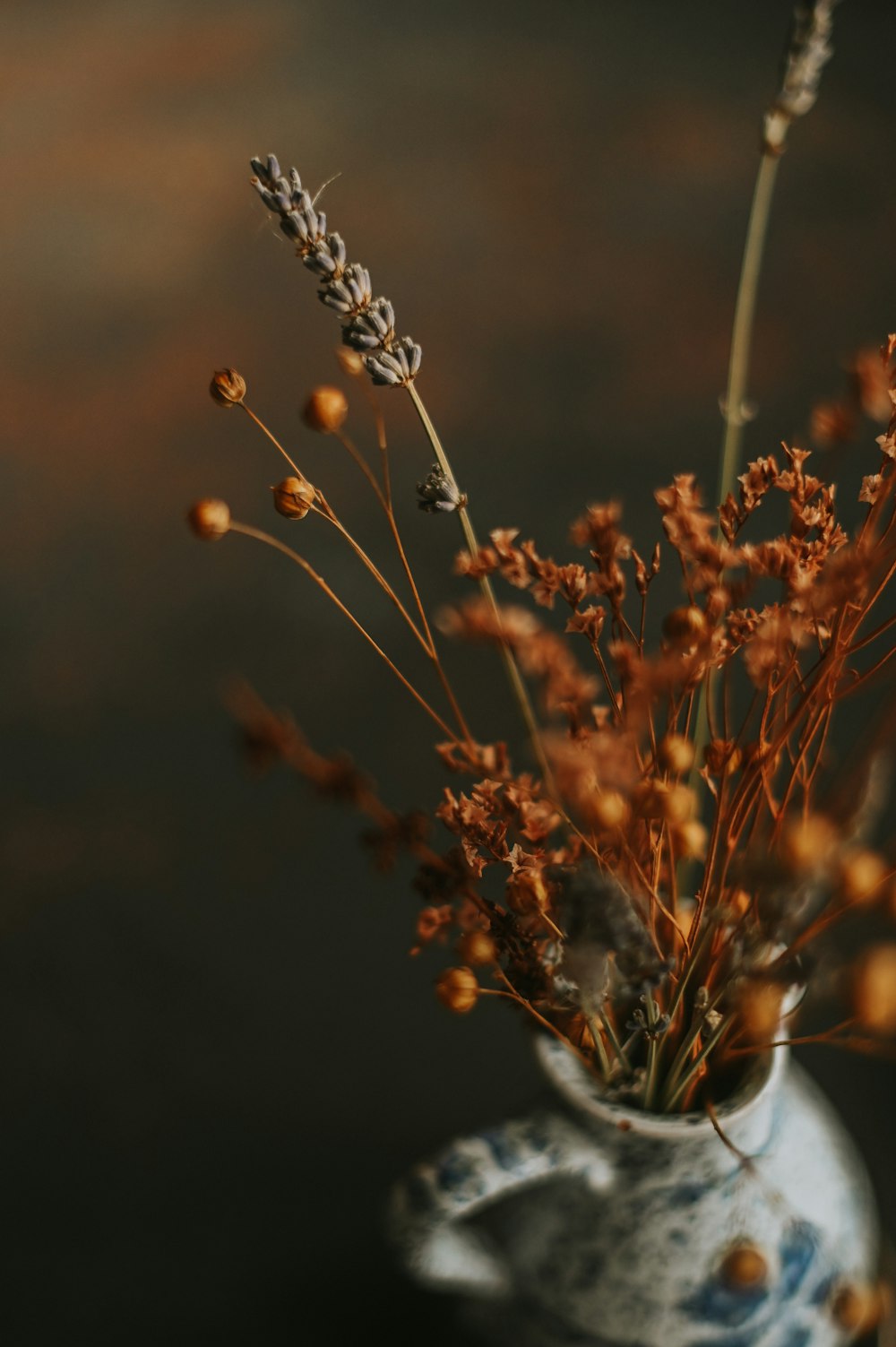 a close up of a vase with flowers in it