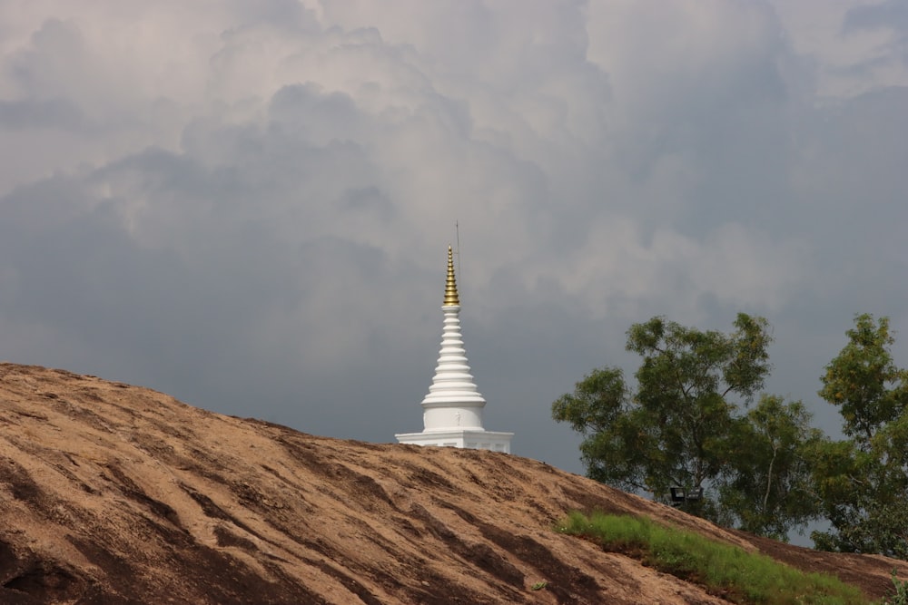 a very tall white building sitting on top of a hill