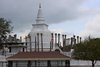 a white building with a red roof and a white spire