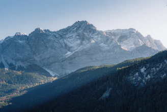 A majestic mountain range with snow-capped peaks and lush valleys.