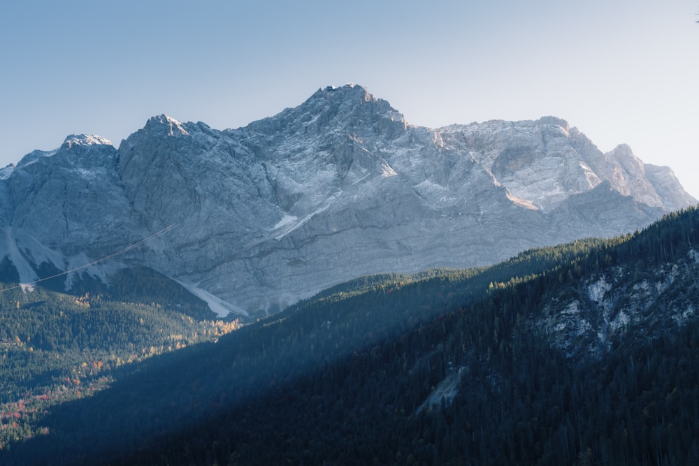 a view of a mountain range with trees in the foreground