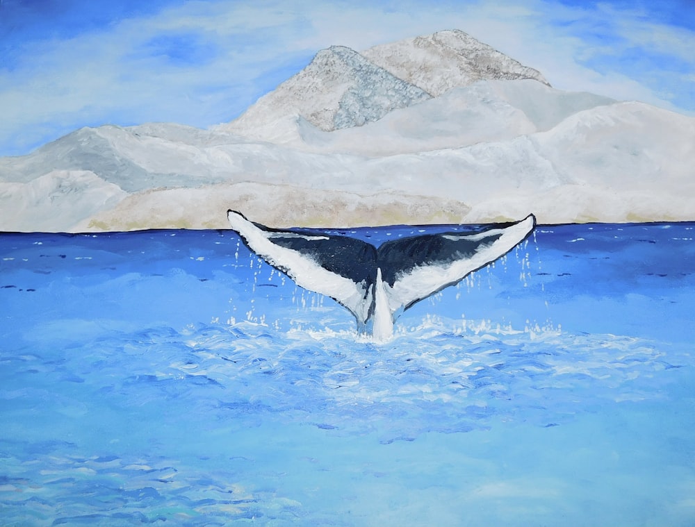 水中のクジラの尻尾の絵