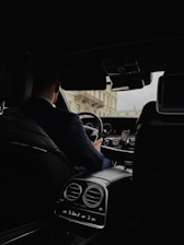 a man driving a car in the dark