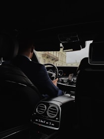a man driving a car in the dark